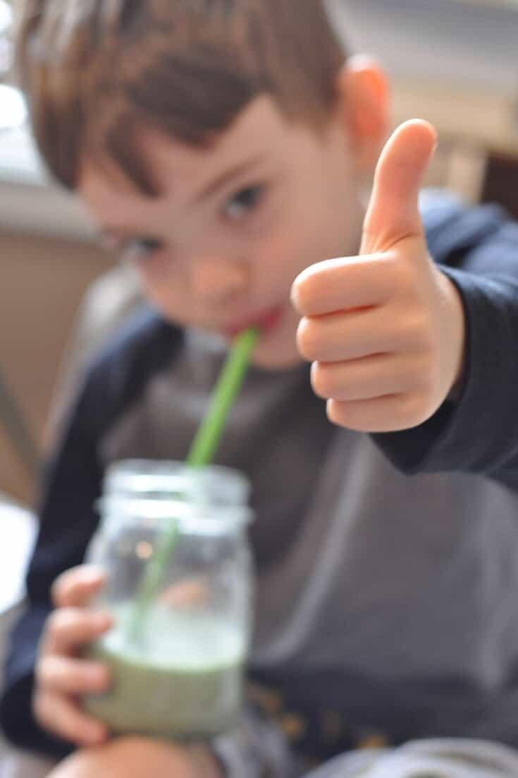 Young child giving a "thumbs up" sign for a traditional diet.