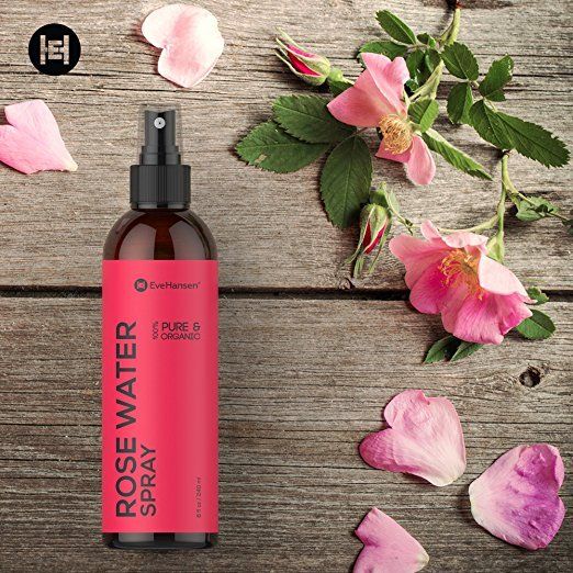 Spray bottle filled with rose water surrounded by rose petals - natural beauty tips (scent)