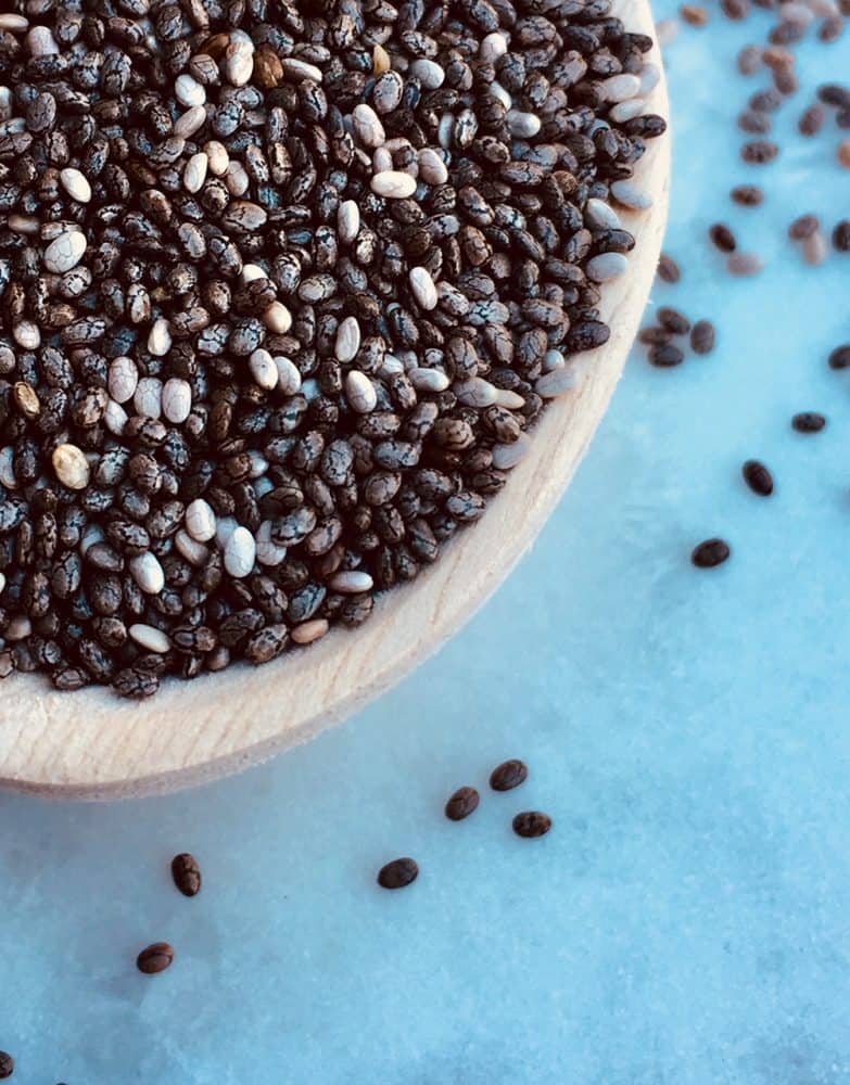 Close-up view of a spoonful of chia seeds, ready to make chia recipes.