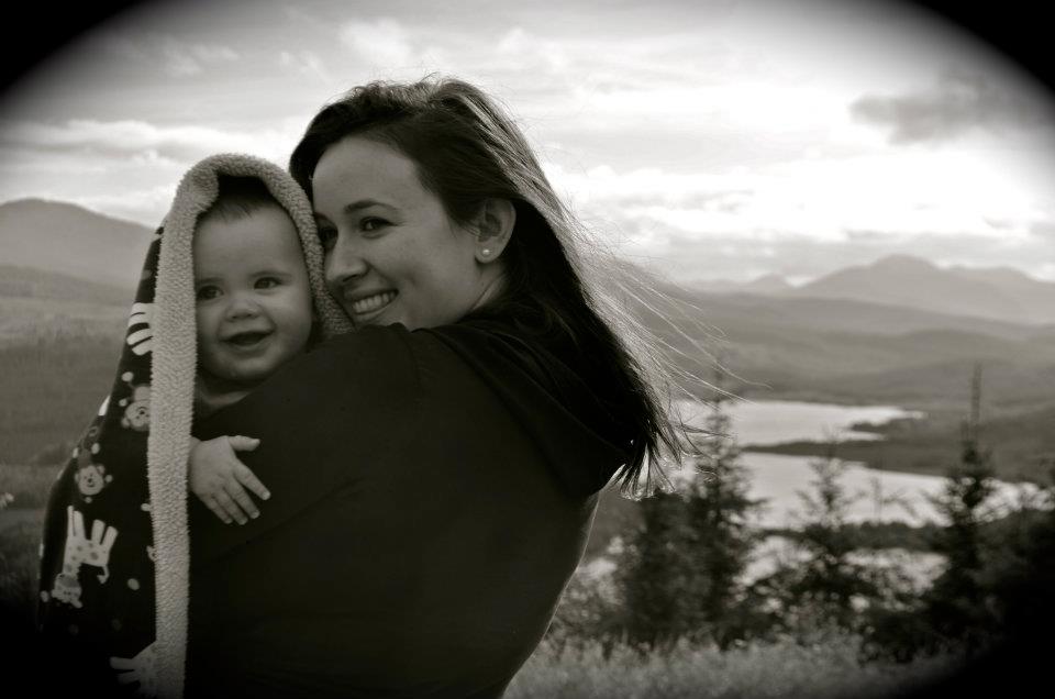 Bible verses about mothers - a black and white photo of a mother holding a baby in an outdoor scene.