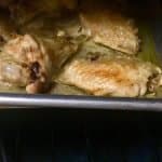 Baking frozen chicken wings in an oven. Close-up shot of a chicken wing turning golden-brown.