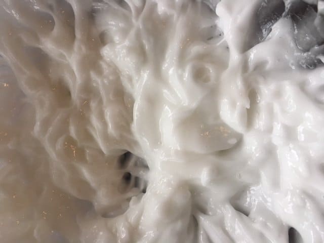 Close-up of creamy, smooth homemade lotion.