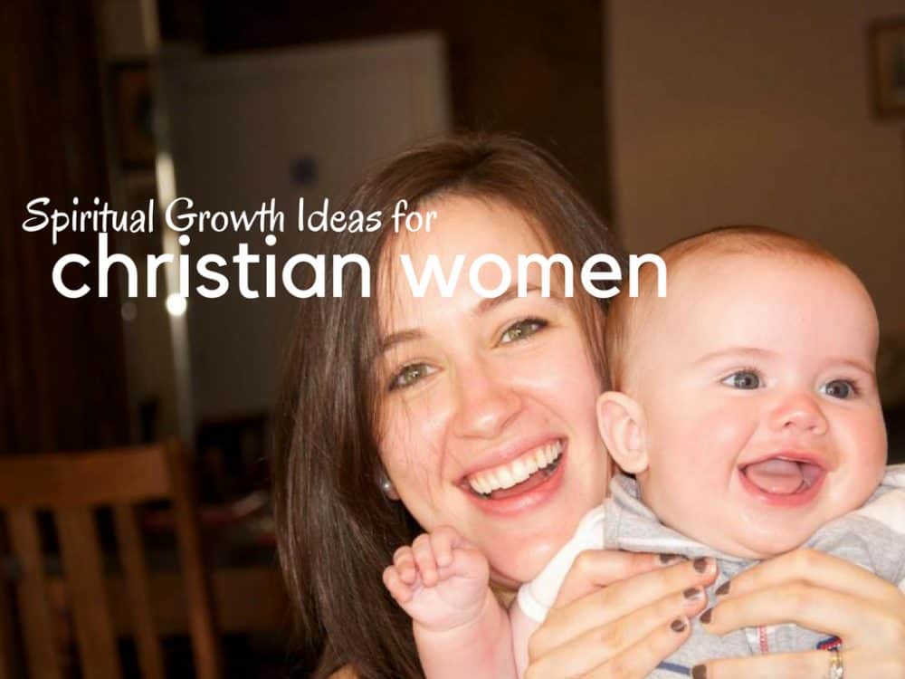 A Christian Woman holding her baby and smiling.