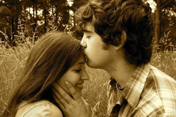 Antique photo of a Christian woman being kissed on the forehead by her husband.