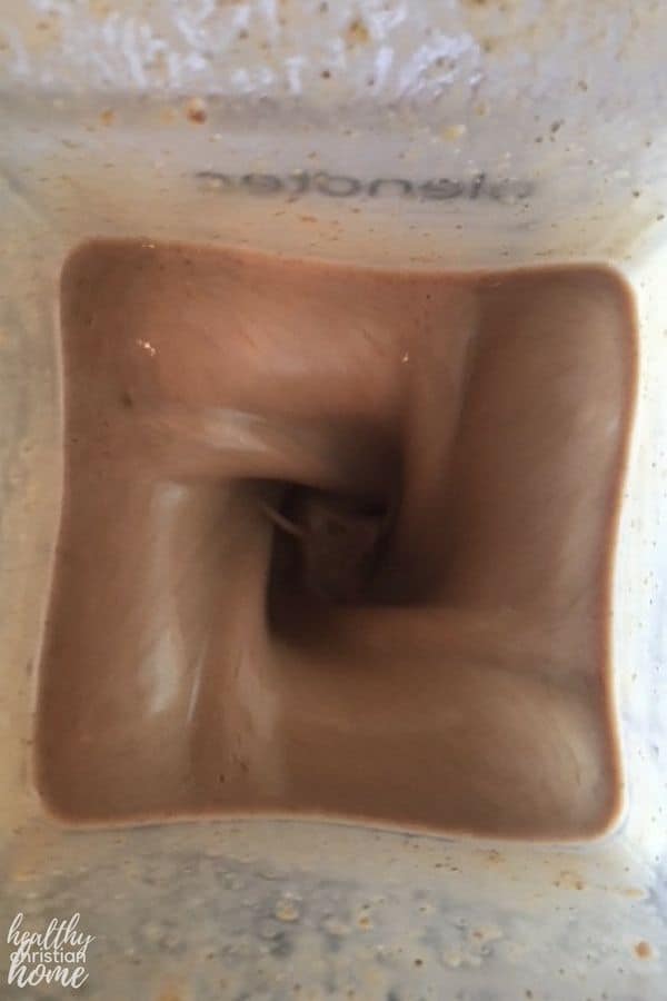 Homemade chocolate shake being blended in a high speed blender.
