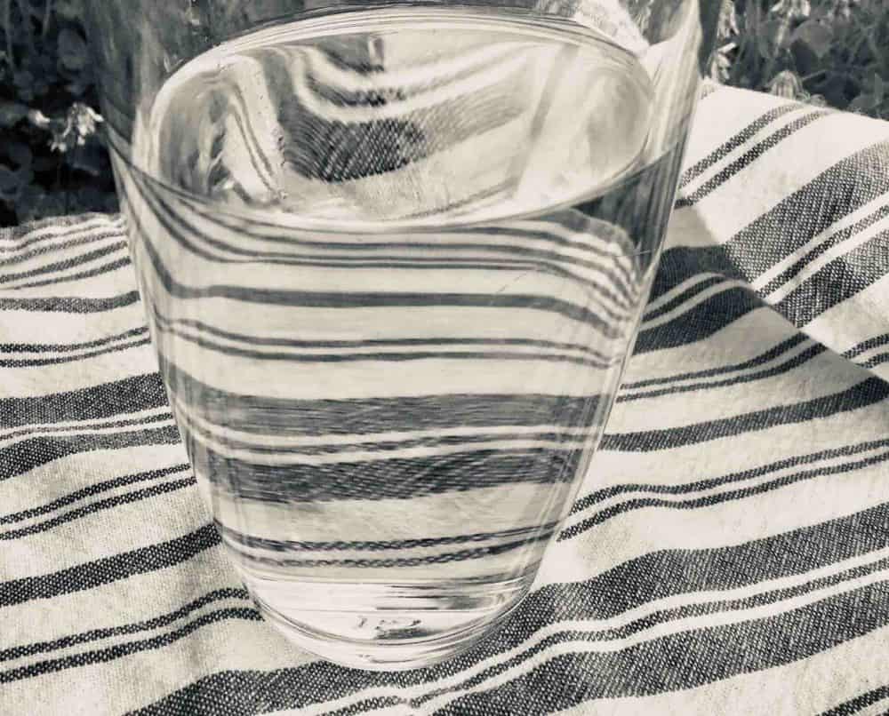 Glass of water on a striped tea towel