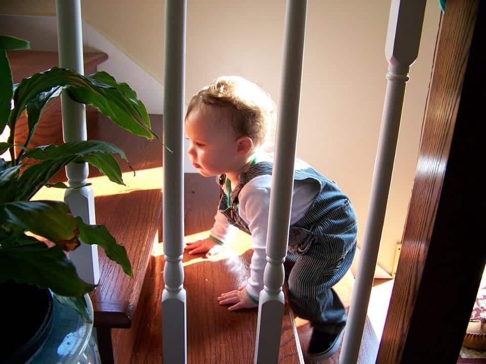 Baby climbing up a staircase