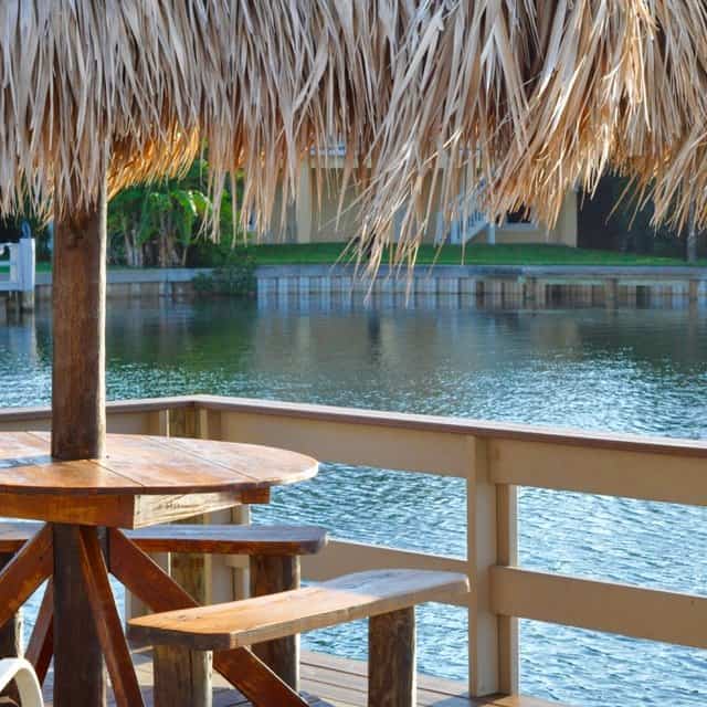 Tropical dining table on a boat dock on the bay.