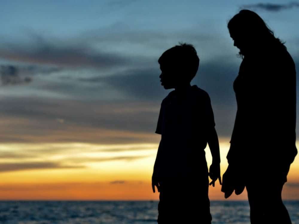 Family bonding watching the sunset on the beach.