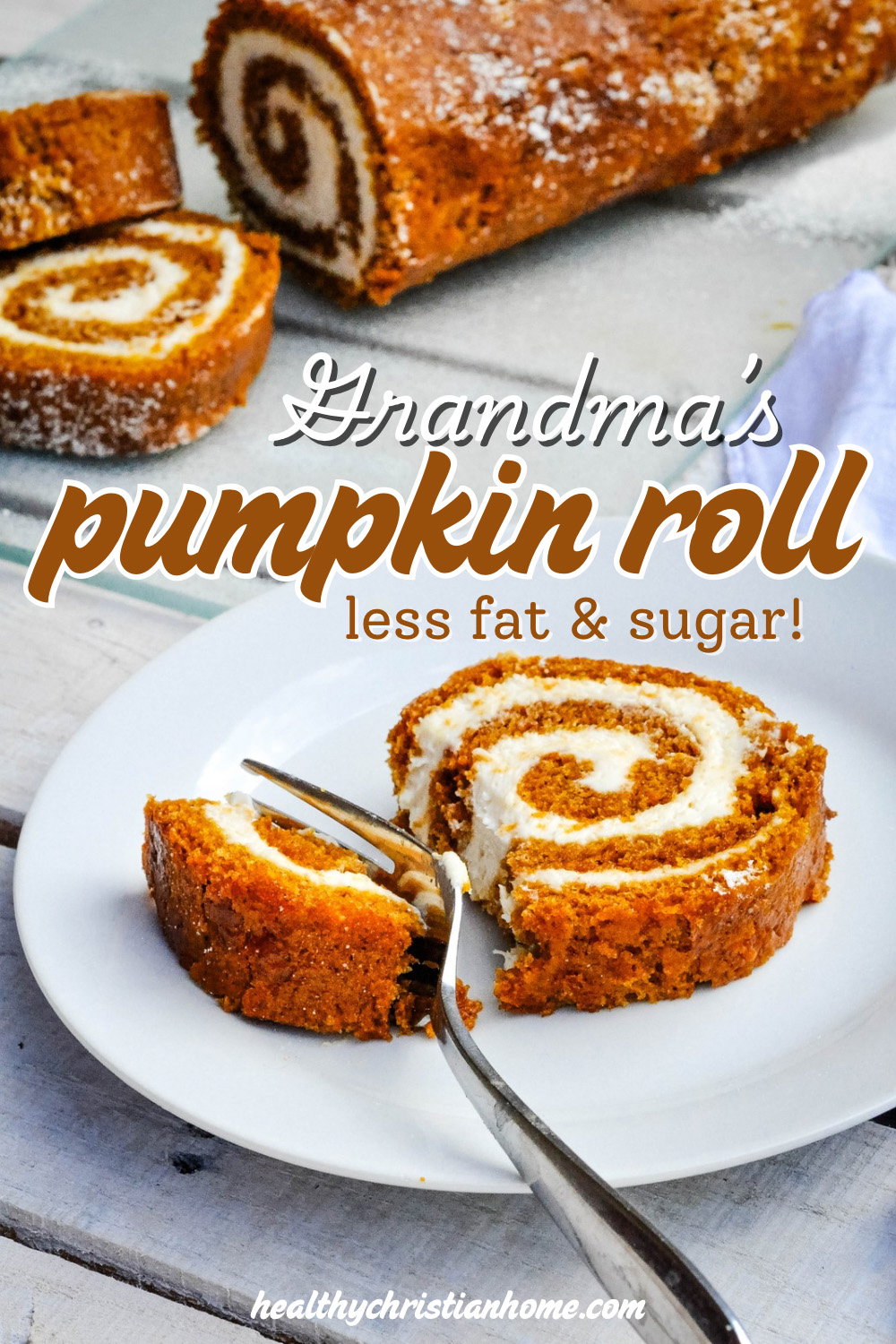 Pumpkin roll cake on a plate with a fork which has a bite cut out.