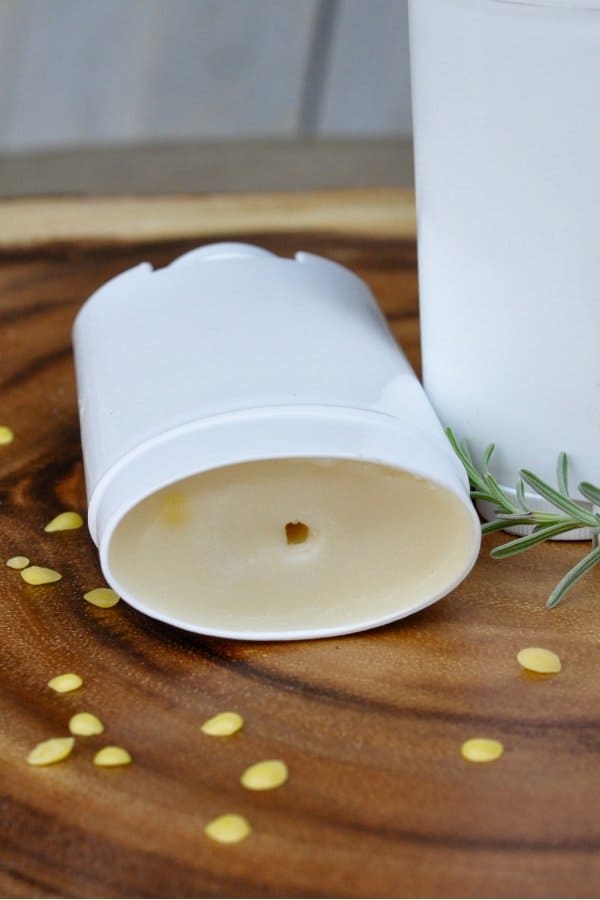 Homemade deodorant on a wooden board with beeswax and lavender.