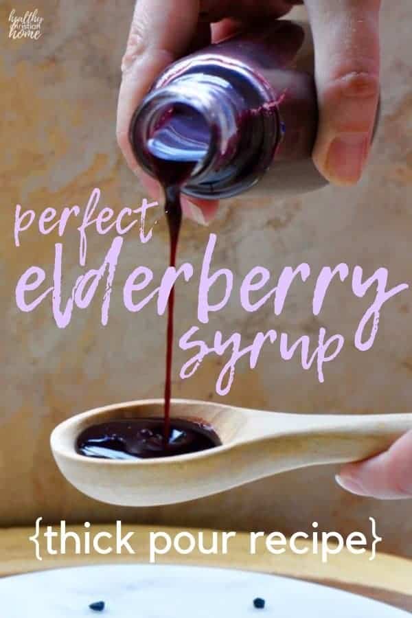 Elderberry syrup recipe text on top of a bottle of syrup being poured onto a spoon.
