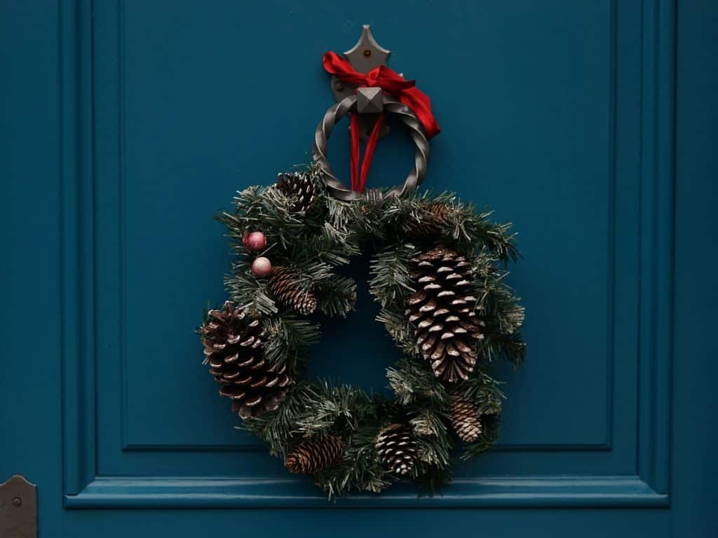 Old fashioned Christmas wreath on a blue front door.