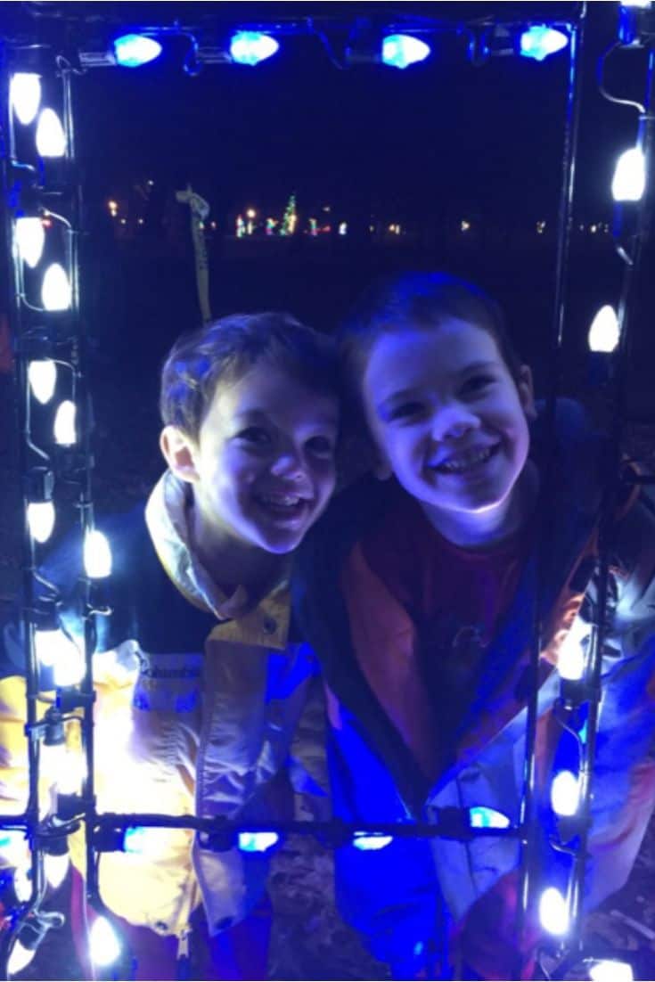 Two children looking at Christmas lights.