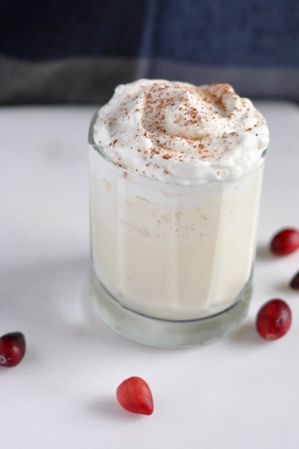 Have you ever wondered how to make eggnog without alcohol? This easy non-alcoholic homemade eggnog is the perfect companion for any holiday gathering. Homemade custard, maple whipped cream and a dash of nutmeg will make this a new holiday tradition for your family. #eggnog #drinks #nonalcoholic #christmas #holidayrecipes #christmasrecipes