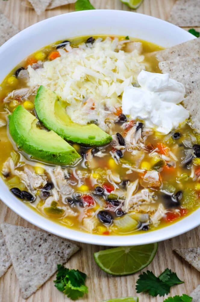 Chuy's tortilla soup copycat recipe in a large bowl with toppings.
