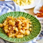 A table full of breakfast food, including pan fried potatoes.