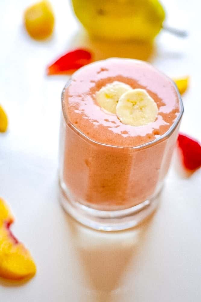 Basic fruit smoothie in a glass topped with banana.