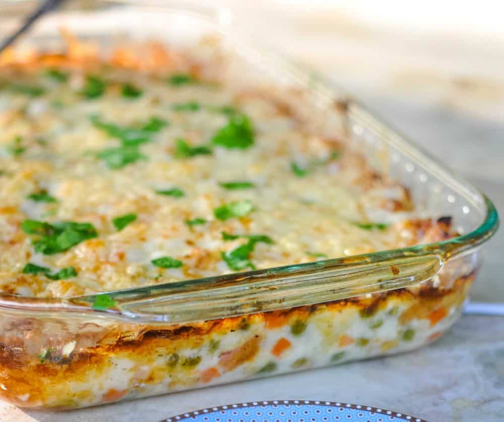 Close up of crustless chicken pot pie sprinkled with parsley.