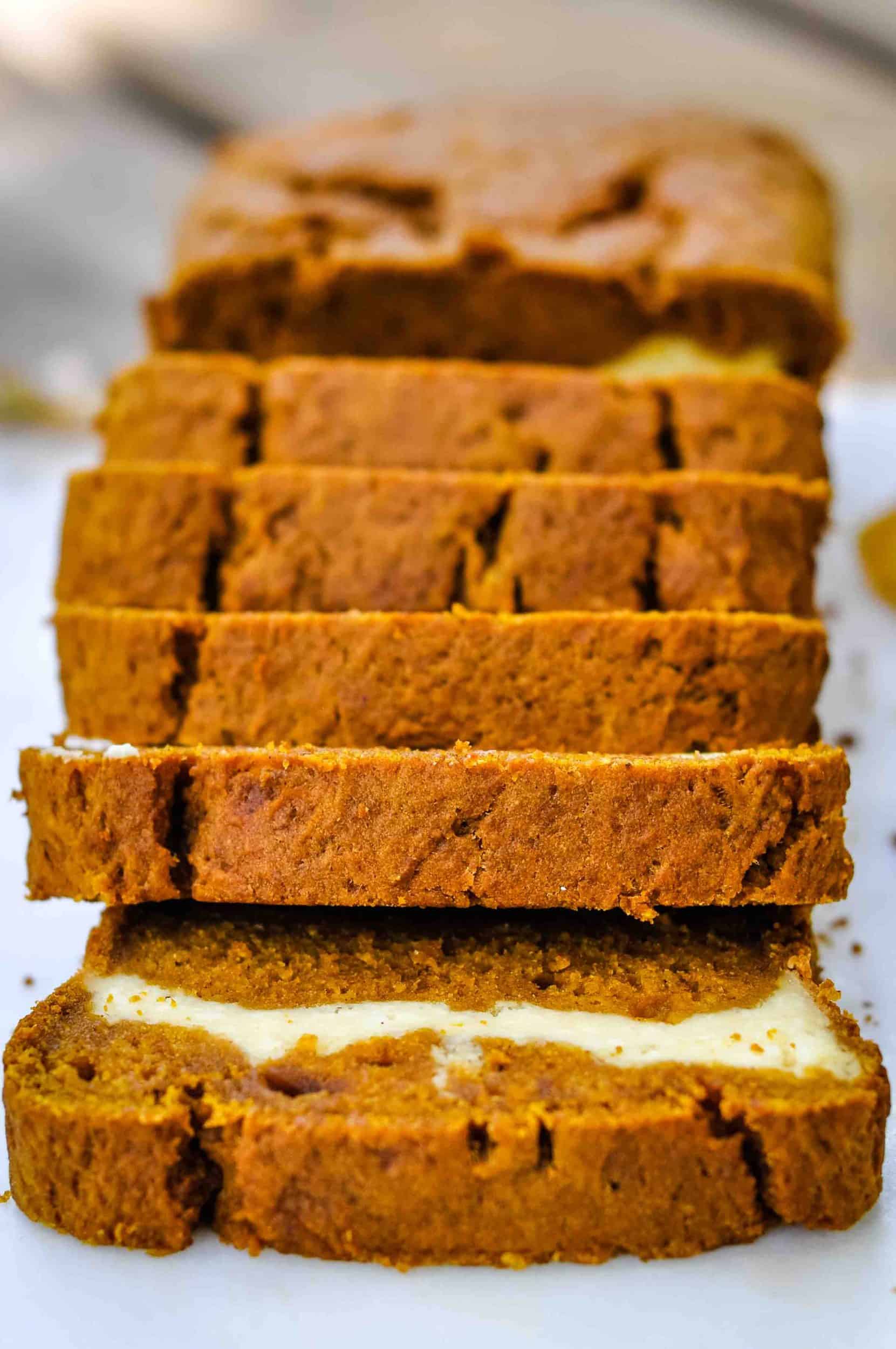 Pumpkin cream cheese bread sliced on a marble tray.