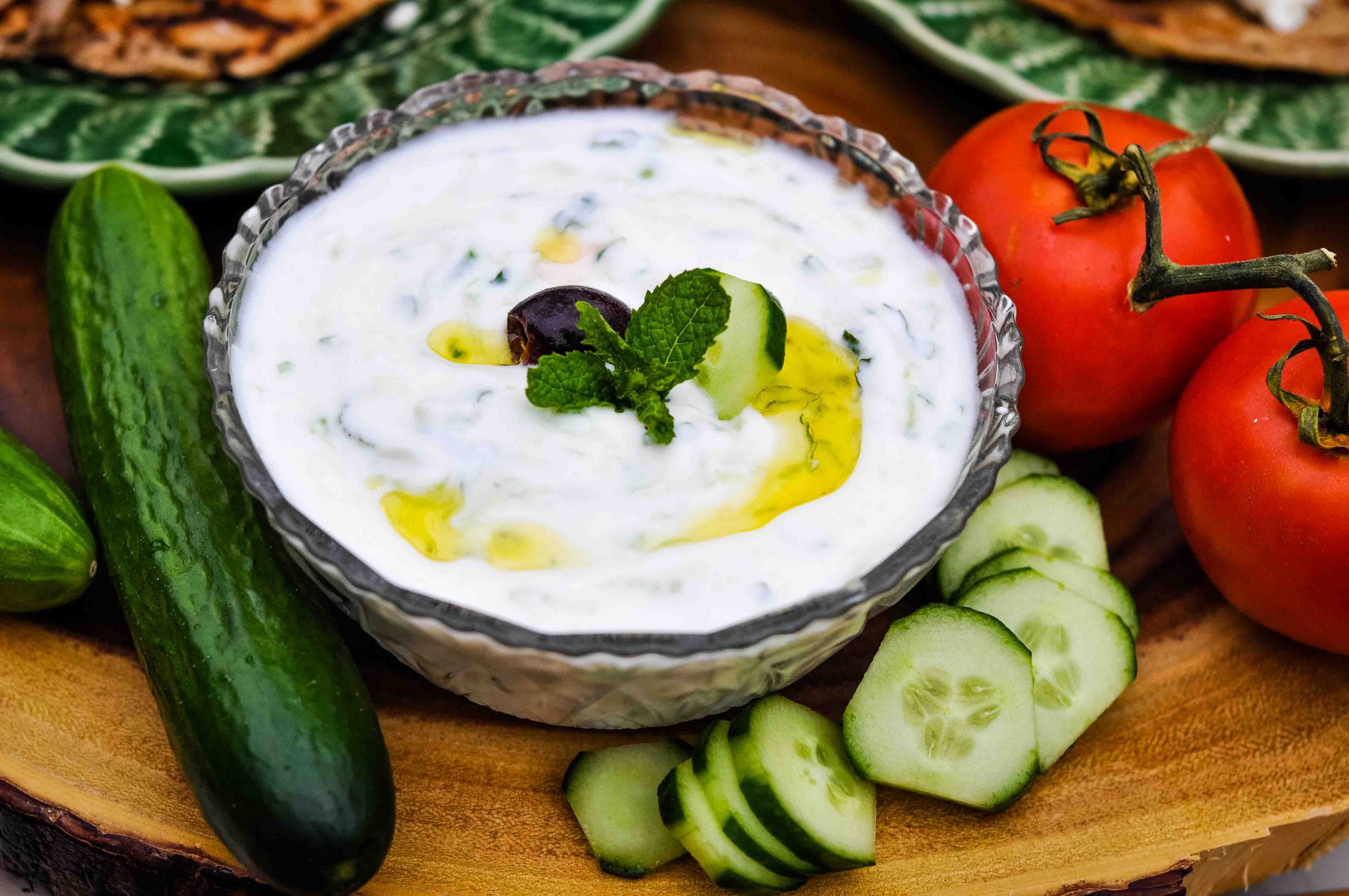 Bowl of tzatziki cucumber sauce topped with mint.