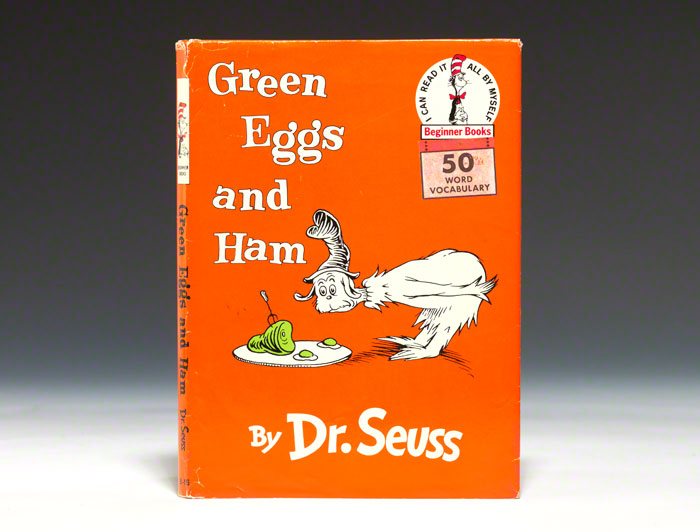 Green eggs and ham on a white plate.