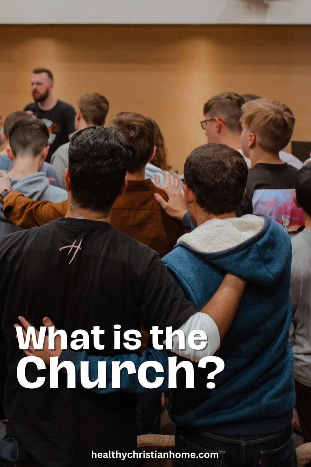 People in a group with text - what is the church.