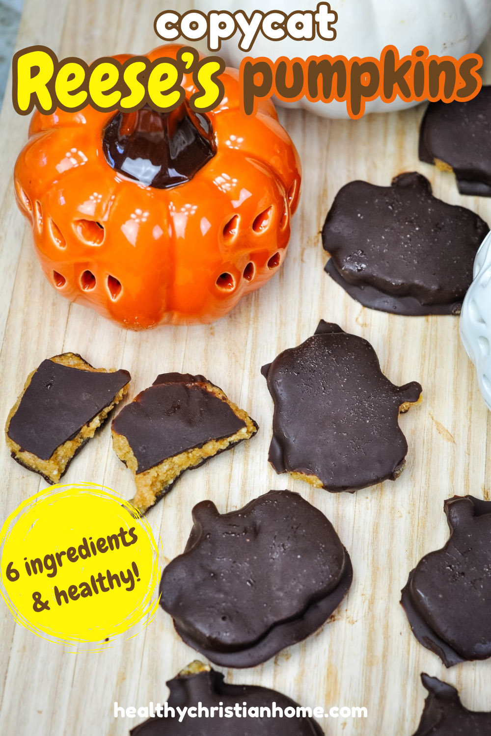 Homemade Reese's pumpkins arranged on a wooden cutting board.