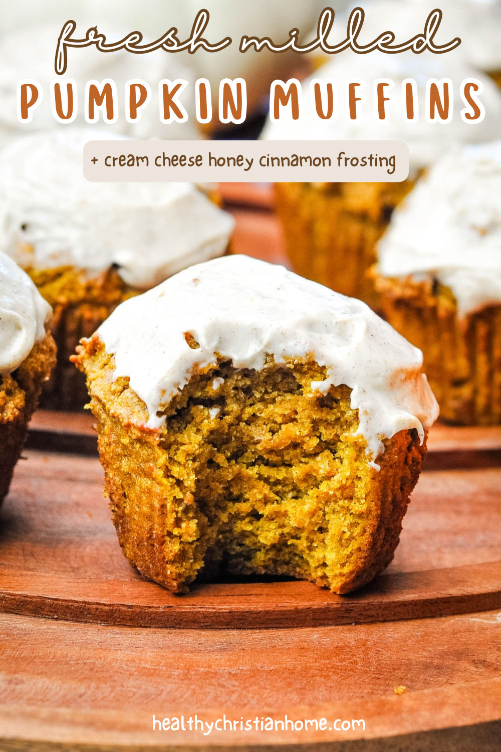Fresh milled pumpkin muffin with cream cheese frosting on a platter.