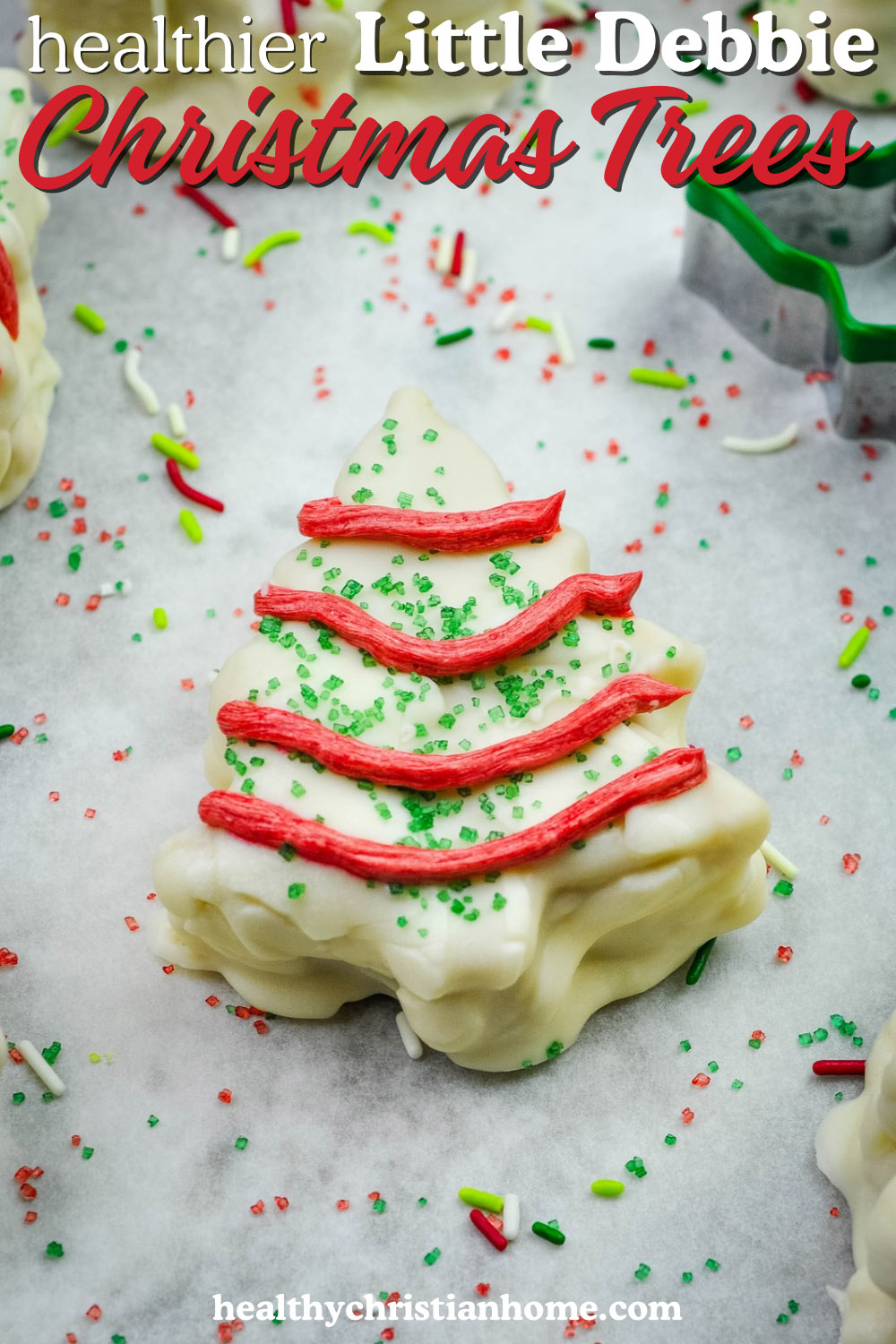 Little Debbie copycat Christmas tree cake on a board surrounded with sprinkles.