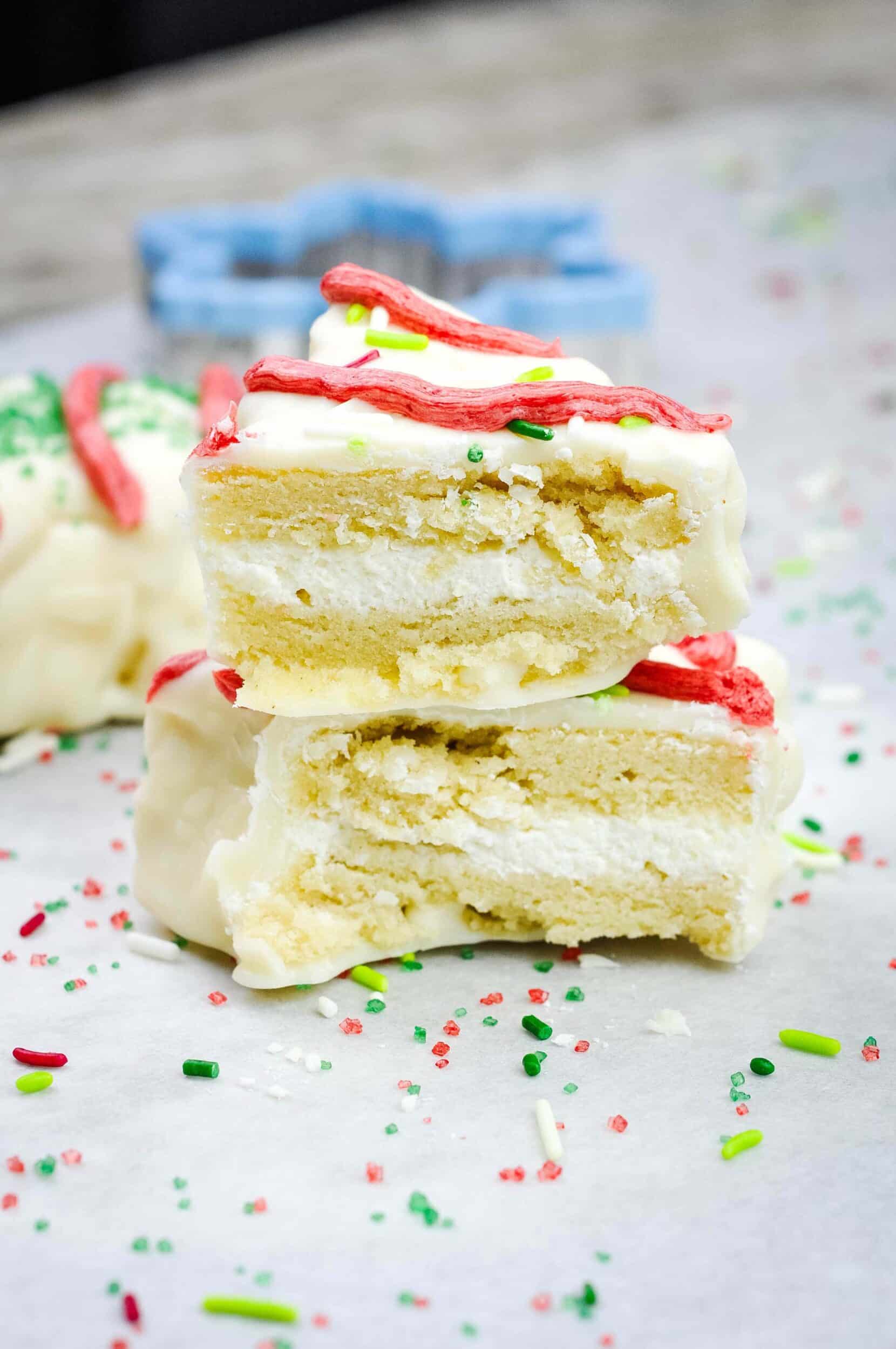 Christmas tree cake cut in half, showing the moist cake and cream filling inside.