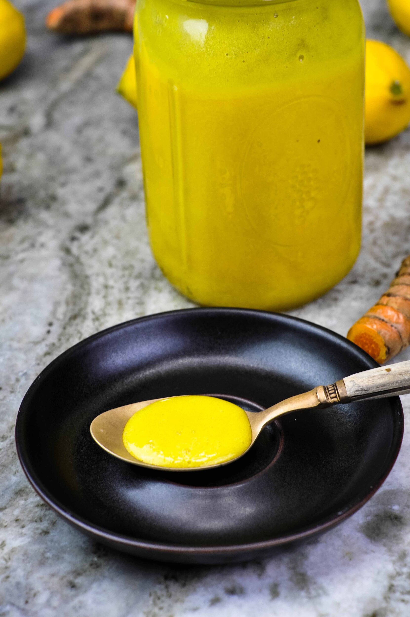 Close-up of pineapple cough syrup on a spoon.