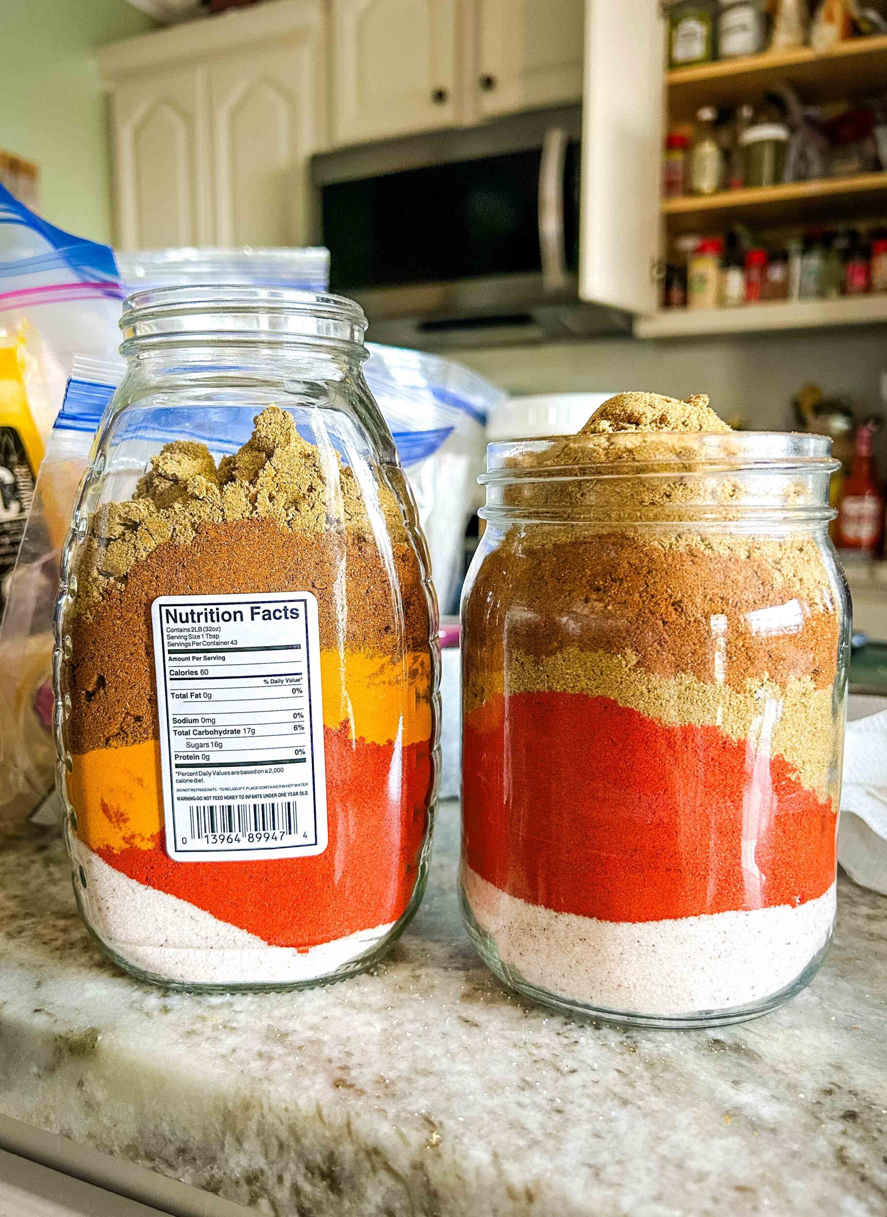 Layers of Indian spices in glass jars.