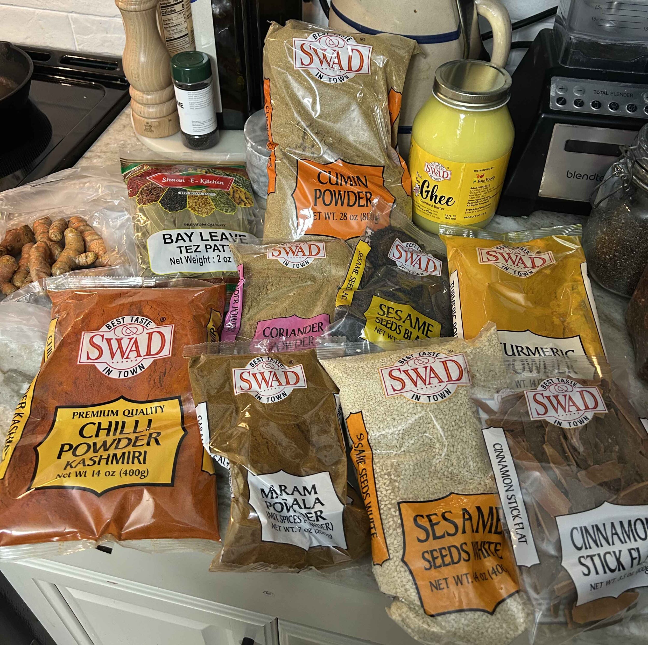 Indian curry spices displayed on a kitchen countertop.